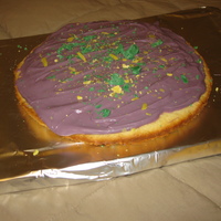 Purple Pizza! This cake was not meant to be so small but it just turned out that way! I used vanilla candy melts as frosting because it was sugar cookie...