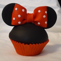 Minnie Mouse Cupcakes CHocolate cupcakes, covered with fondant, mounded buttercream underneath/ fondant bows and ears