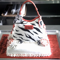 Dooney & Bourke 3D 50Th Anniversary Cake All Fondant Cake including straps. Sheet cake is German Chocolate with fondant hand painted flowers.