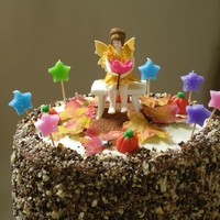 Fall Birthday Fairy, Bench, Leaves & Pumpkins are all made from sugar paste. Butter cake filled with custard and frosted in Mascarpone Cream, sides...