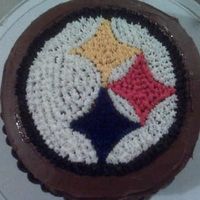 Steelers Cake Yellow cake. Chocolate icing (canned). Piping gel and wax paper to make design. Colored vanilla (canned) icing for the design. Used star...