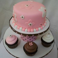 Brown And Pink Themed Baby Shower Tower This tower was used for 2 doz chocolate and vanilla cupcakes with a 6" topper . Fondant covered and accents