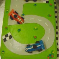 Birthday Cake This was a birthday cake that I made for my grandsons 5th birthday. Buttercream on cake, all cars made with fondant/gumpaste. My grandson...