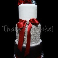 Silver, Red, Black Wedding Cake LOVE this cake! :)This cake is 3 extended teirs (10" 8" & 6" in 6" height)The bottom tier is covered in black...