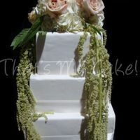 White Wedding Cake I brushed this 3 tier white fondant covered cake with white luster dust just to add a little something extra..The flowers really bring it...
