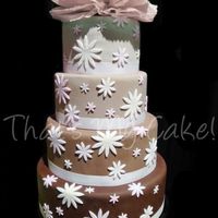 Varrying Browns This cake is 4 tiers coverd in varrying colors of brown fondant.The flower cut outs (as well as the ribbon) are all pink.