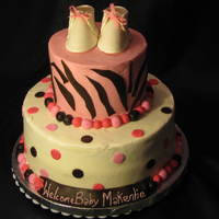 2 Tier Baby Shower Cake Baby Shower Cake, covered in Sugarshack Buttercream, Fondant circles, zebra stripes, balls. Gumpaste Baby booties. This is my first Baby...