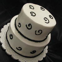 Birthday Cake A simple buttercream tiered cake with black swirls. Vanilla cake with Sugar Shack Vanilla Buttercream.