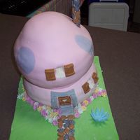 Smurfette's House This is coconut cake with vanilla butter cream filling and covered in fondant. The flowers are gum paste, the door, window shutters, and...