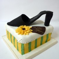 Mummy's Shoe Chocolate cake with Chocolate buttercream filling. Cake is covered with fondant. The shoe is made out of fondant as well and is edible. It...
