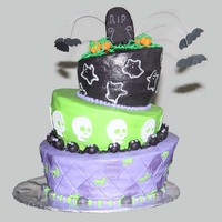 Topsy Turvy Halloween Cake Three tier buttercream with fondant and gum paste accents.