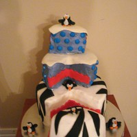 Birthday Cake Cake is buttercream icing with fondant zebra stirpes and gumpaste penquins.