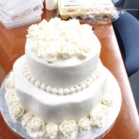 First Wedding Cake For Class Bottom is a petal pan cake and top is round. Fondant roses and crisco cream icing.