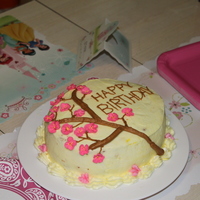 Apple Blossoms white cake with almond cream cheese filling, buttercream frosting and royal icing for the apple blossoms.