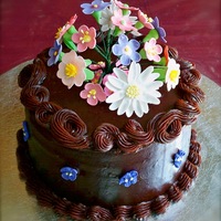 Mom's Chocolate And Flowers Cake I made this small cake for my mom's birthday. It was my first time piping ganache. The flowers are gum paste.
