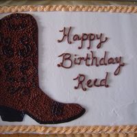 Cowboy Boot Free-hand cowboy boot in chocolate with black accents; all buttercream