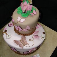 Butterfly And Fairy Baby Shower Cake This was a topsy turvey baby shower cake. We were copying the babies bedding. All fondant with fondant deco and a fondant fairy :) TFL