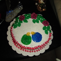 Christmas Roses And Ornaments Chosolate cake with peanut butter filling, in butter cream with candy clay roses and leaves. i handdrew in the glitter gell some ornaments...