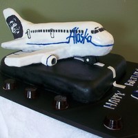 Alaska Airlines Plane Plane is vanilla cake with B/C filling. Belly of plane and wings are carved styrofoam. Plane is covered in MMF with royal icing detailing....