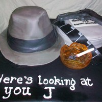 Humphrey Bogart Cake Humphrey Bogarts hat, gun and cigarette on a Maltese Falcon film reel. Hat and film reel are cake. Gun is fondant, and ashtray is sugar...