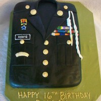 Rotc Jacket Chocolate cake with chocolate ganache filling. Cake is covered in MMF with royal icing details.