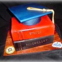 Graduation Cake Mt first attempt at Books. SUPER fun to do. Grad cap is cake as well with a foam core top covered in fondant. EVerything else is edible....