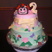 Lady Bug 2Nd Birthday This was inspired by 2 versions of it on cc. The bug is rice krispy and modeling chocolate. Iced in bc and fondant accents. I love it!