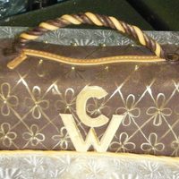 50Th Birthday Purse Cake Chocolate purse cake with raspberry filling. Covered in chocolate fondant, handle is wire wrapped in chocolate and gold colored buttercream...