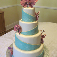 Paisley Orchid Wedding Cake Design inspired by Plant Cake's design. Teal and paisley pattern from the invitation, orchids made to match their centerpieces. Thanks...