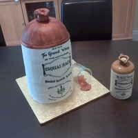 Whiskey Bottle The actual bottle is sitting next to the cake. The glass is real, "ice" cubes and "whiskey" inside are sugar. TFL!