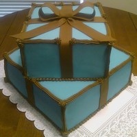 Gift Box Cake French Vanilla cake with Tiffany blue fondant , brown fondant bow, and brown buttercream accents. Bottom layer are 2 10" and the top...
