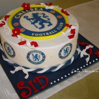 Chelsea Football Cake An 8 inch chocolate cherry ripe mudcake, layered and coated with dark chocolate ganache and covered in fondant for an avid Chelsea...