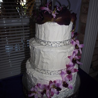 Wedding Cake Vanilla sourcream cake with strawberry buttercream filling with Vanilla buttercream. Flower are silk.