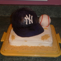 Yankee Baseball Cake In memory of my husband's grandpa, i true yankee fan. Hat is chocolate cake, base is yellow cake, brim is gumpaste, ball is krispy...