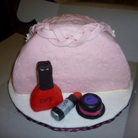 Sophisticated Lady Toiletry clutch with handmade accents pieces using rice cereal treats covered in fondant.