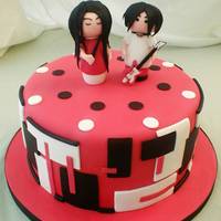 White Stripes Birthday Cake Design inspiration for the side decoration taken from a band photo. The little gumpaste Meg and Jack are in the style of Momiji dolls.