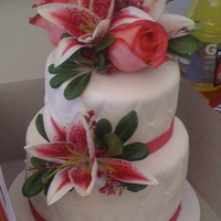 Pink Lily Wedding Cake My first wedding cake! Classic yellow cake w/strawberry filling, top tier is classic yellow w/chocolate moose. This was a small wedding of...