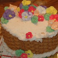 Basket Weave Cake Oval cake, Buttercream icing, Brown Basket Weave, with white Rope along the border, and some royal per made flowers.....