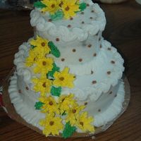 Yellow Lily Pooka Cake Royal icing Yellow lily flower, brown buttercream Pooka-DOTs, on a white buttercream two tiered cake. my first two tiered cake.