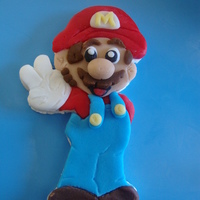 Antonio's Super Mario Cake 12" and 8" covered in buttercreme with fondant accents. Mario is gumpaste and fondant. Special thanks to CakeMommyTX for...