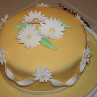 Wilton Fondant And Gum Paste Course Finale Cake Chocolate cake with vanilla buttercream, covered in fondant. Gumpaste daisies.