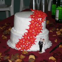 My First Wedding Cake It was a yellow cake with buttercream frosting and royal icing poinsettias. The bride wanted something simple and "Christmasy".