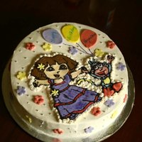 Dora And Boots Cake This is a Dora and Boots cake for my daughter's 4th birthday. The cake is a chocolate cake with a Ganache filling. I frosted it with...