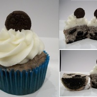Oreo Cupcake white cake with oreo bits and a big oreo bottom and vanilla buttercream frosting.