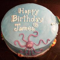 Under The Sea Cake yellow cake with raspberry filling and vanilla buttercream frosting and marshmallow fondant and chocolate decorations.