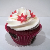 Red Velvet W/ Cc And Fondant red velvet cake with cc frosting and tiny fondant flowers and red velvet cake w/ choc bc frosting and tiny candy pearls.