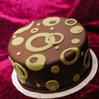 Little Brown & Green Cake This was an experimental cake...needs more "experimenting". Covered in Chocolate Fondant with olive green fondant circles (could...