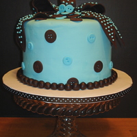 Cute As A Button! This little boy baby shower cake is three layers of fluffy classic white cake filled with chocolate buttercream. The hand made chocolate...