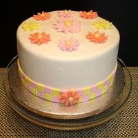 Checkerboard Daisy I made this cake for a small bridal luncheon. The daisies were made with a fondant/gum text mixture. The cake was a classic white cake with...