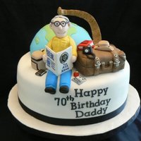 Travellers Birthday Cake This was made for a retired social studies teacher who loved to travel. Fondant/gumpaste figures. Suitcase was rkt covered in fondant